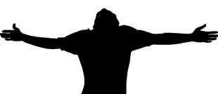 Silhouette of a man throwing his head back and arms outstretched