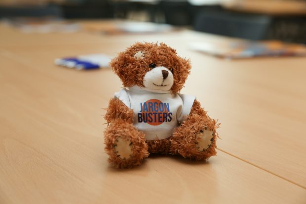 A teddy bear wearing a jargon buster t-shirt