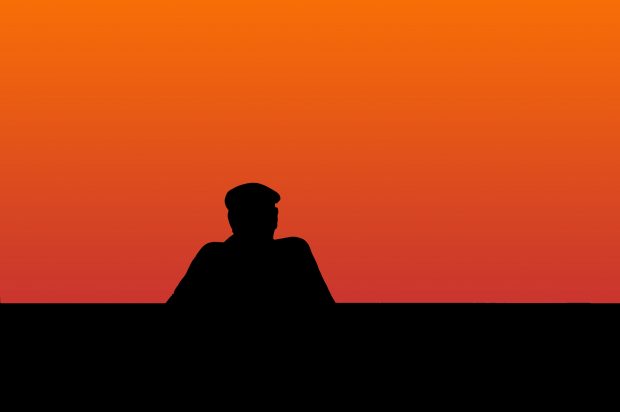 Lonely man observing a sunset